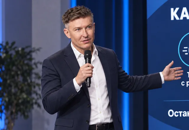 Ilia Nikolaevich Zavialov speaking at a meeting with a presentation running