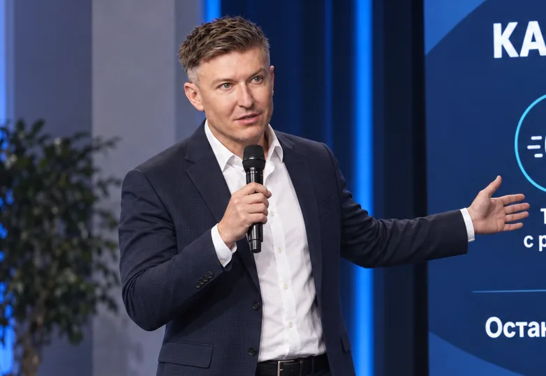Ilia Nikolaevich Zavialov speaking at a meeting with a presentation running